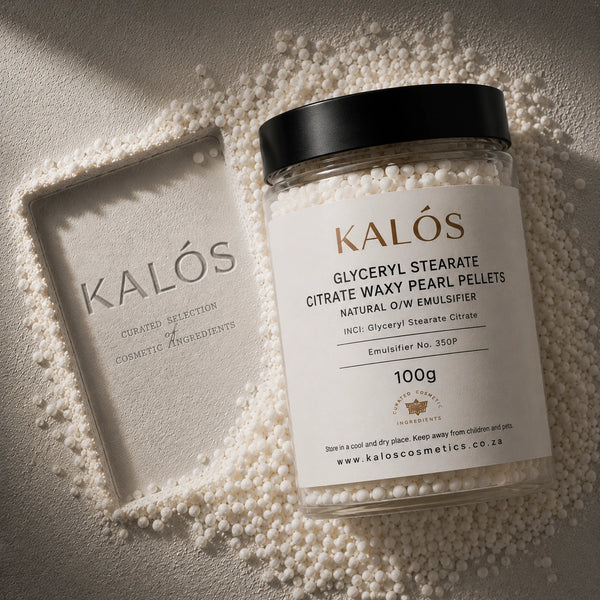 Jar of Kalós cosmetic ingredients surrounded by pearls on a neutral background