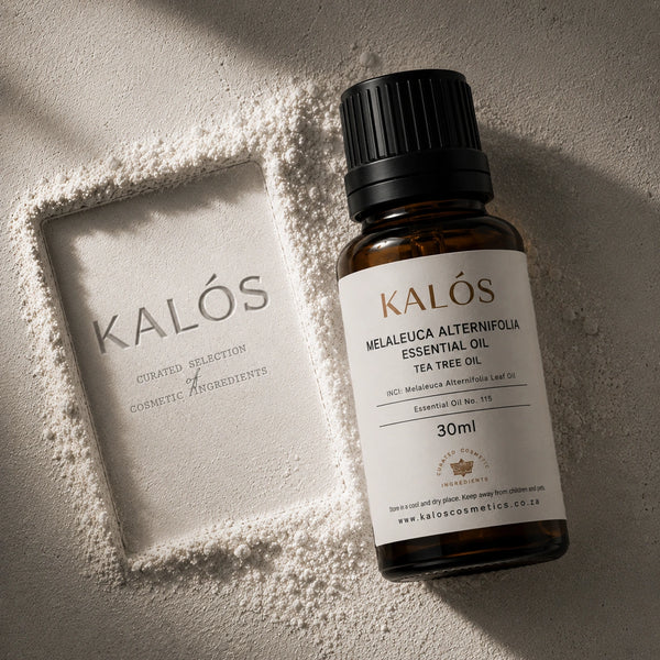 Bottle of Kalós essential oil on a textured surface with a branded box.